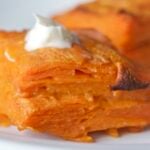 Sweet potato gratin on plate with creme fraiche on top.