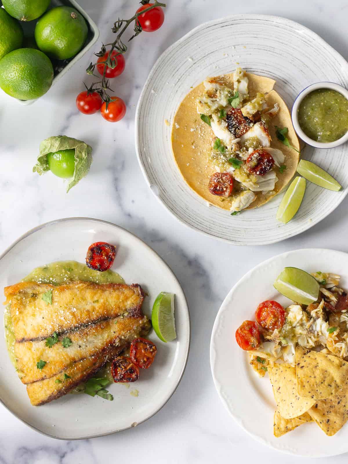 Crispy barramundi with warm salsa verde on plates.